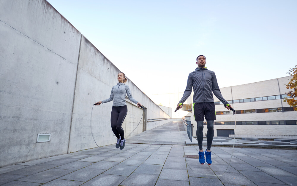 Man,and,woman,exercising,with,jump Rope,outdoors