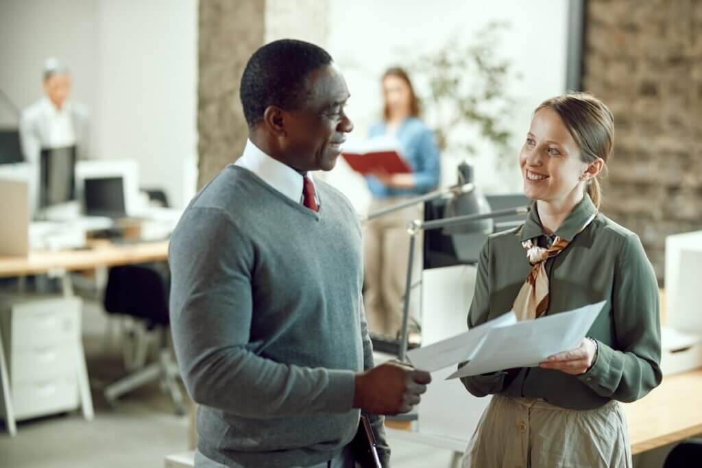 Happy Business Colleagues Going Through Paperwork 2022 11 23 17 28 52 Utc