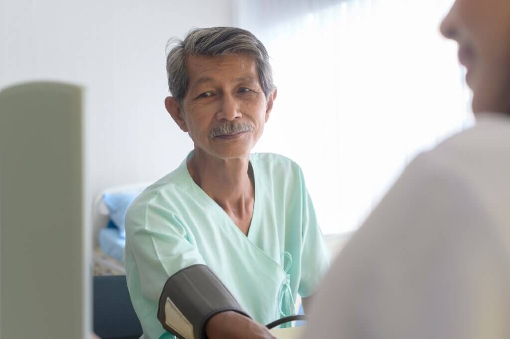 Asian Senior Male Patient Is Consulting And Visiting Doctor In Hospital..