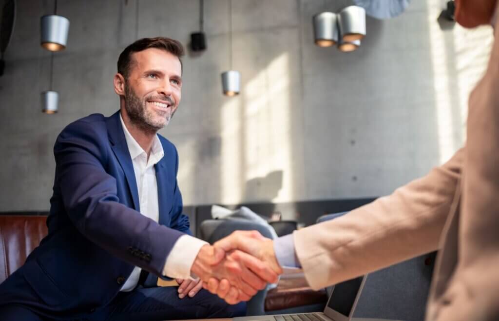 Business People Shaking Hands During Meeting