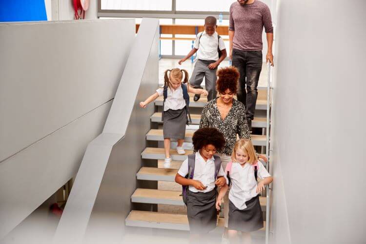 Teacher And Pupils Walking Down Stairs In Busy Ele 2024 10 21 13 29 34 Utc
