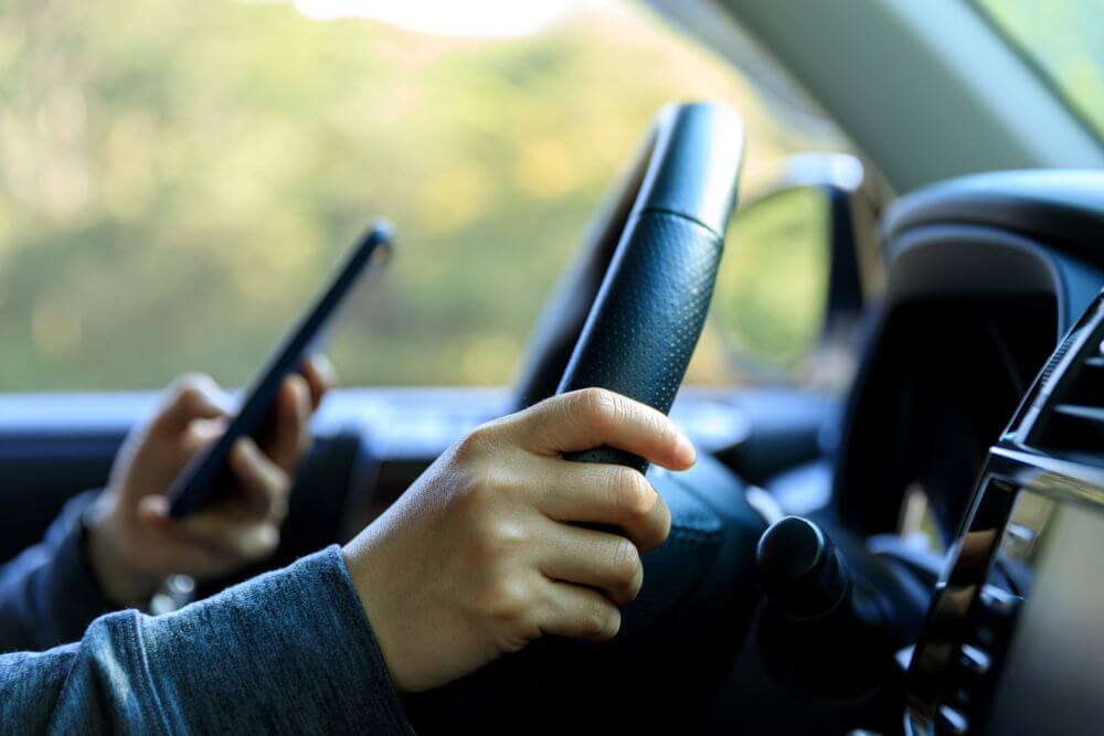 Holding Phone While Driving A Modern Vehicle 2026 03 16 02 34 02 Utc